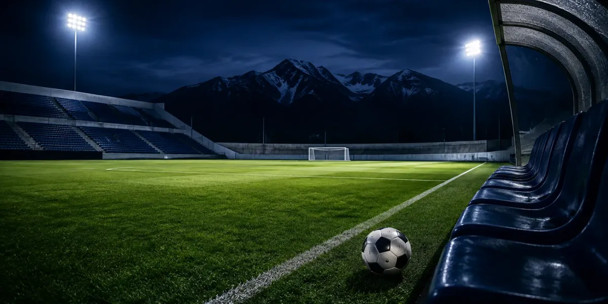 Original editorial illustration of a soccer ball beside empty bench seats at a mountain-backed field at night.