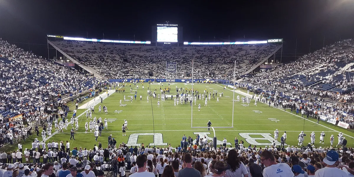BYU football players line up during a game, used as licensed editorial imagery for BYU Sport Nuts.
