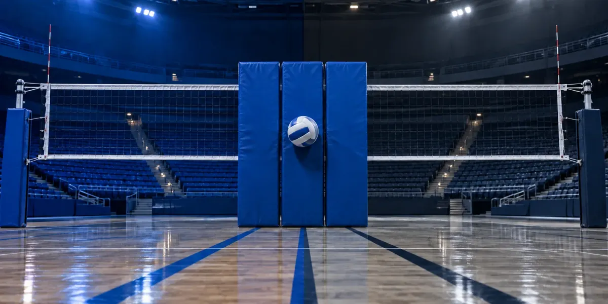 Original editorial image of one volleyball meeting three blue blocking pads on an empty court split between BYU royal blue and Utah State navy and gray.