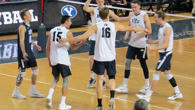 BYU men’s volleyball players celebrating during a match, used as real editorial imagery for a men’s Olympic sports guide.