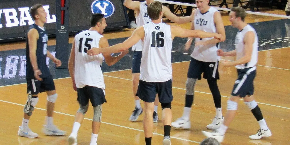 BYU men’s volleyball players celebrating during a match, used as real editorial imagery for a men’s Olympic sports guide.