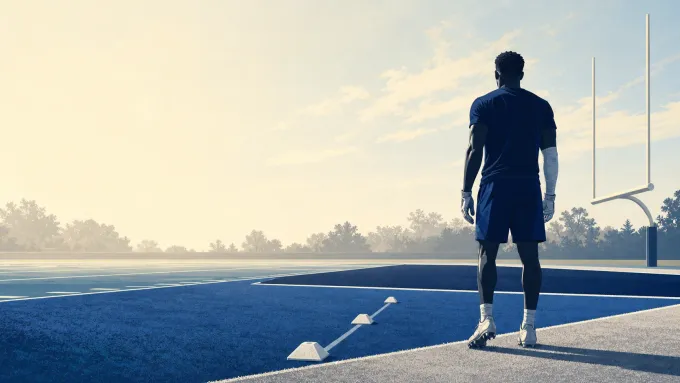Original editorial illustration of an anonymous football defender approaching a practice field through a rehabilitation lane.